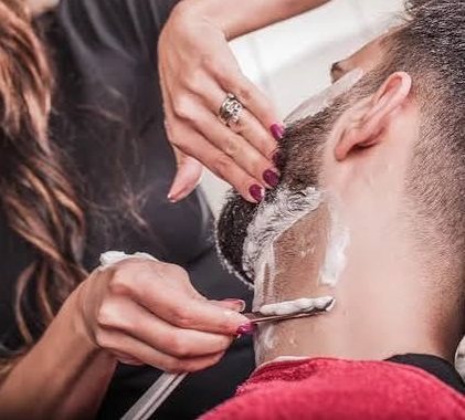 Razor shave along a client's neckline